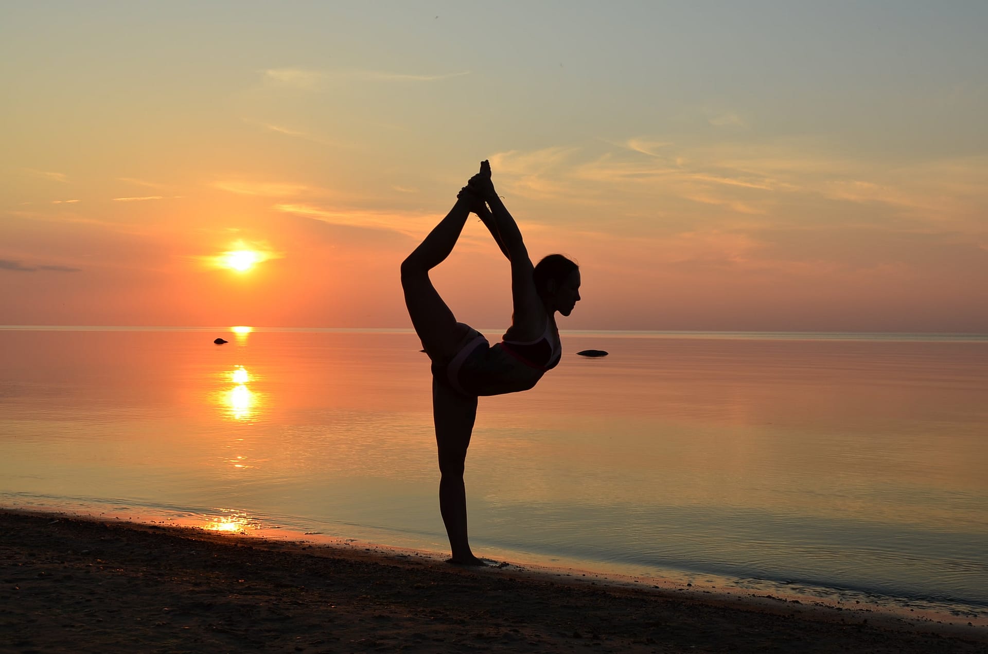 woman doing beach yoga